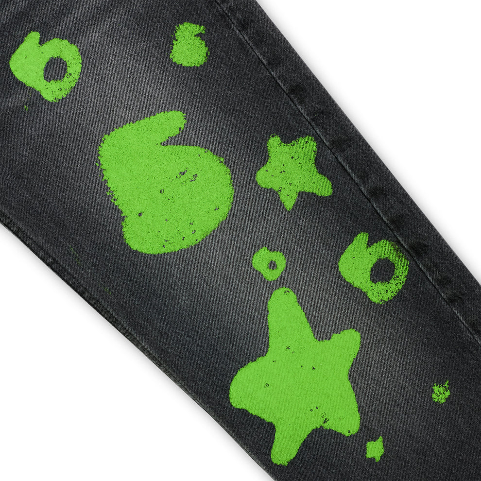 Faded black denim pant with vibrant green Beluga stamp design, custom hardware, and straight leg fit.