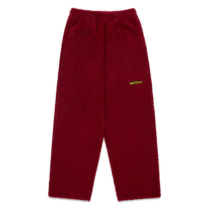 Red teddy fleece pant with elasticized waistband and yellow Sp5der logo.