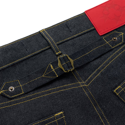 Dark wash denim jeans with yellow stitching, a brass buckle-back cinch, and a red leather back patch.