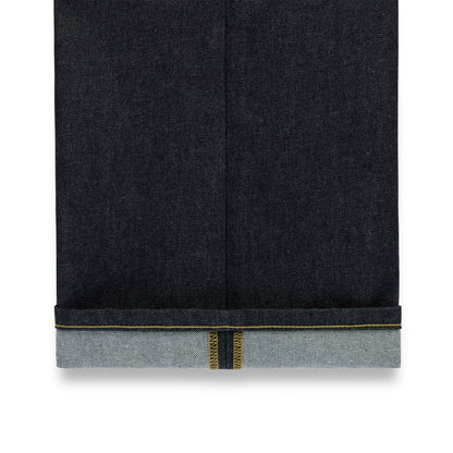 Dark indigo denim jeans with a straight leg fit and a cuffed hem revealing yellow selvedge stitching.