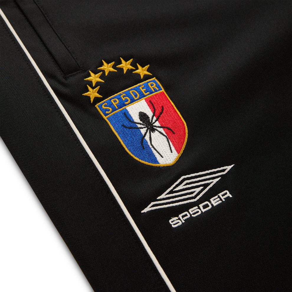 Black ATLANTA TRACK PANT with SP5DER crest logo, white piping, and SP5DER branding.
