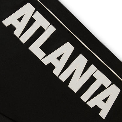 Black ATLANTA TRACK PANT with bold white "ATLANTA" graphic and contrast piping.