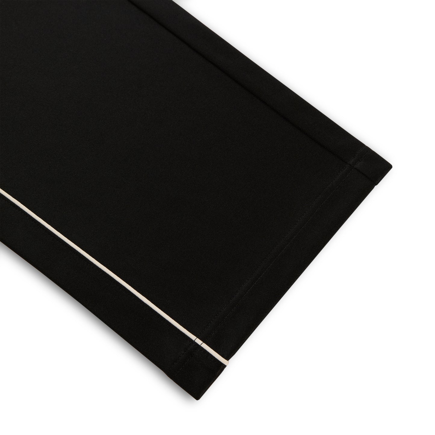 Black polyester Atlanta Track Pant with white contrast piping, wide-leg silhouette.