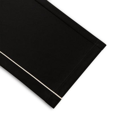 Black polyester Atlanta Track Pant with white contrast piping, wide-leg silhouette.