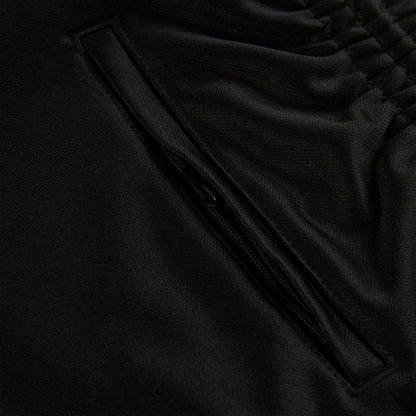 Close-up of black ATLANTA TRACK PANT, showing zippered pocket and elastic waistband.