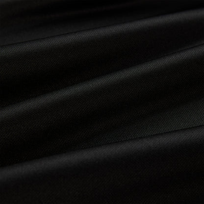 Close-up of black athletic polyester fabric with subtle folds, showing its smooth texture.