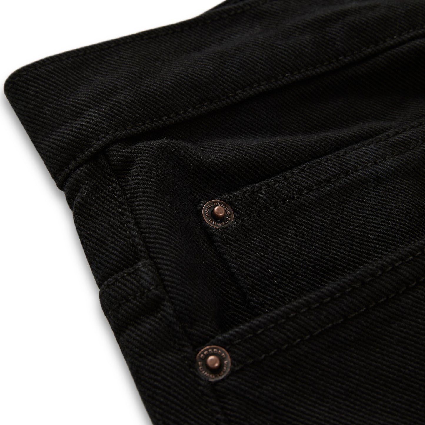 Close-up of black V3 denim pants with custom branded hardware and belt loops.