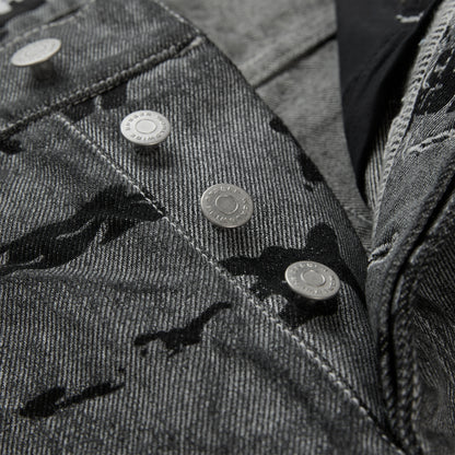 Washed black denim pants with an all-over print, branded silver hardware, and red contrast stitching.