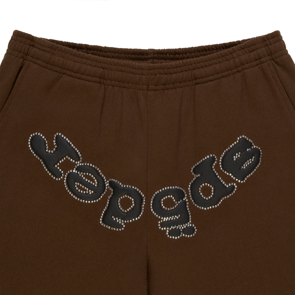 Brown cotton fleece sweatpants with "SP5DER" text in rhinestones across the crotch.