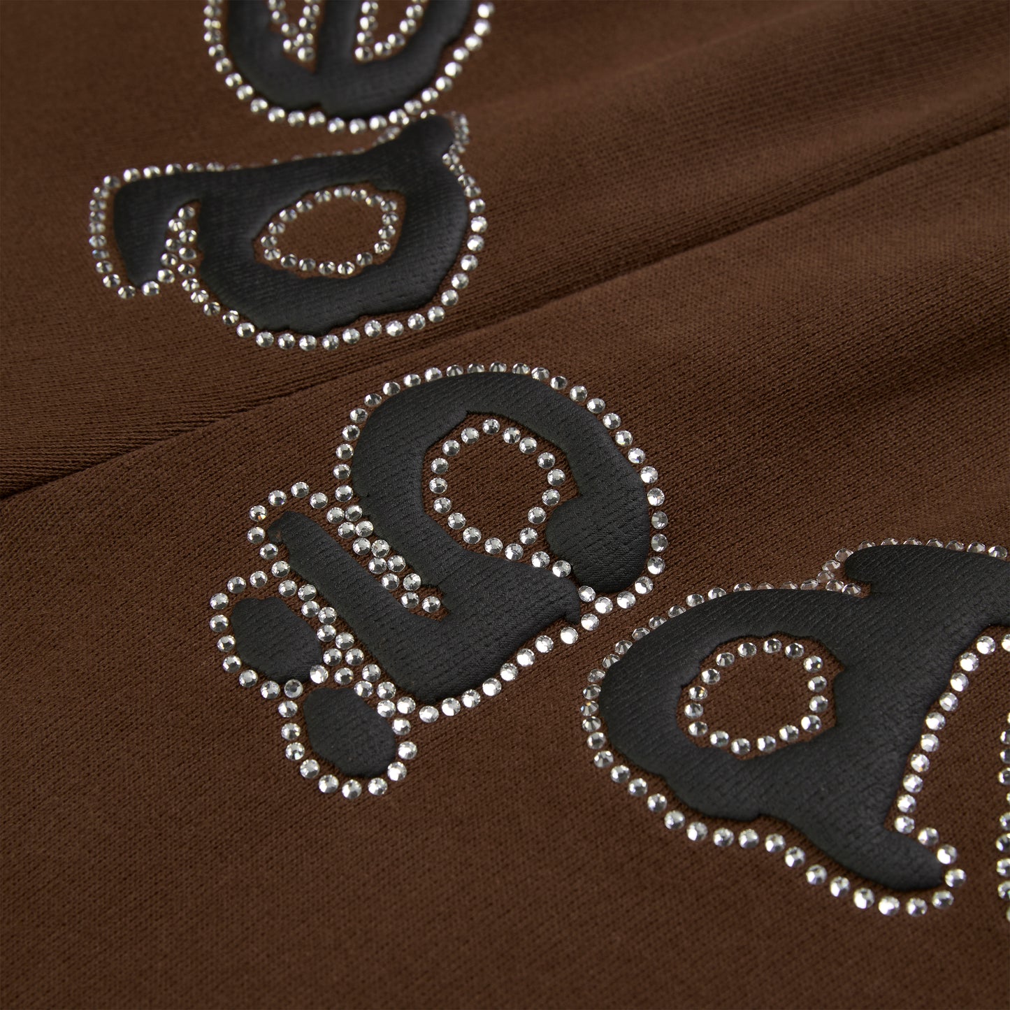 Brown cotton fleece sweatpants with black puff print "OG" logo outlined in rhinestones.