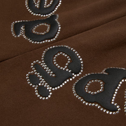 Brown cotton fleece sweatpants with black puff print "OG" logo outlined in rhinestones.