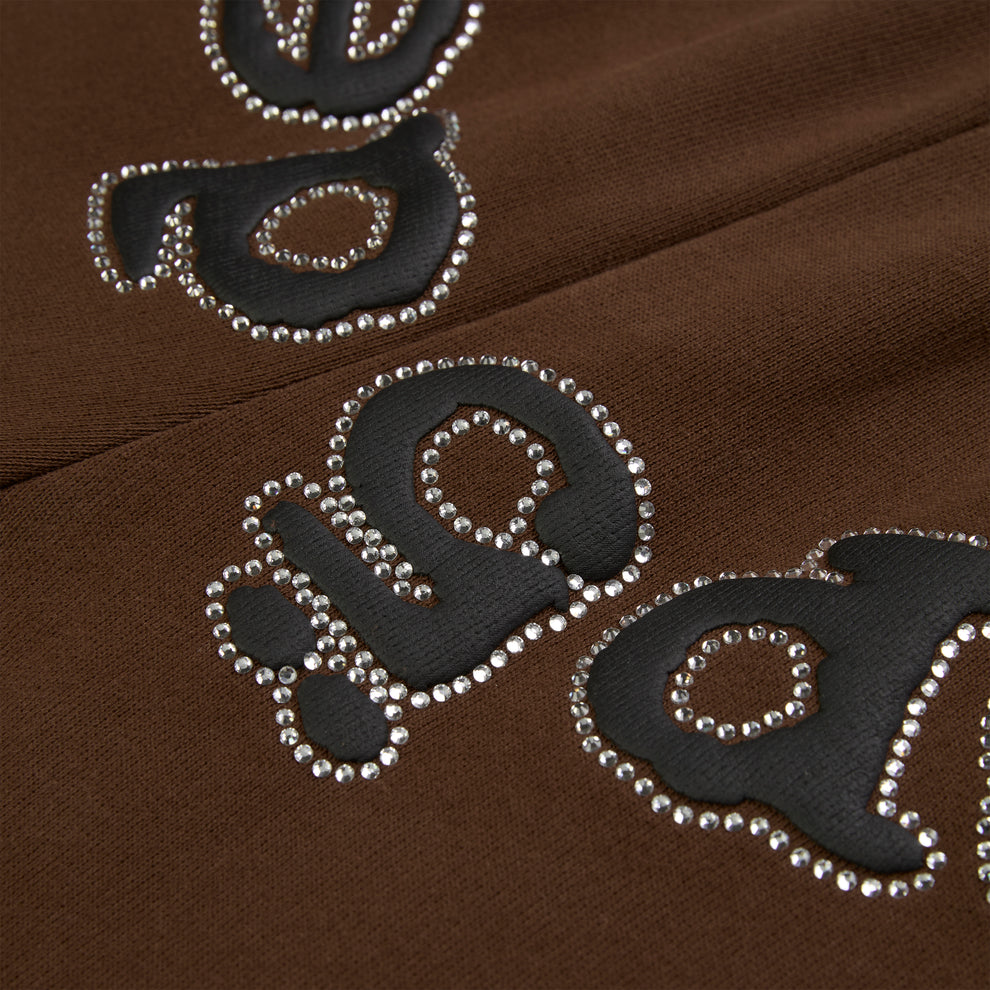 Brown cotton fleece sweatpants with black puff print "OG" logo outlined in rhinestones.