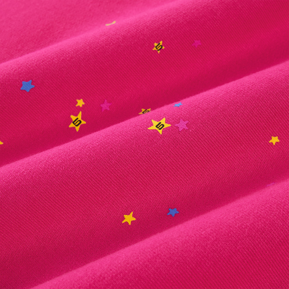 Pink cotton fleece sweatpant with scattered yellow, blue, and pink star prints.
