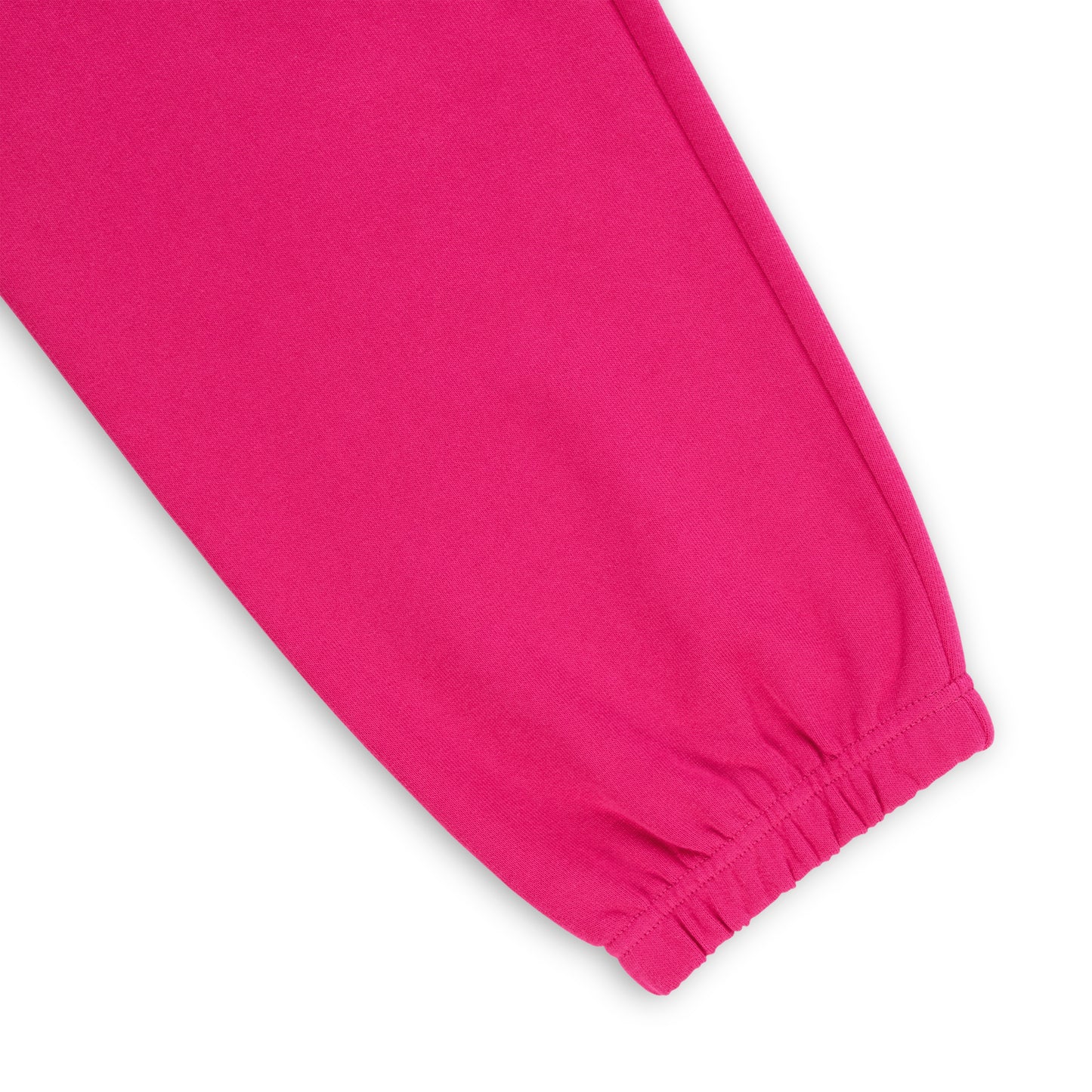 Close-up of a vibrant pink cotton fleece sweatpant leg with an elasticized cuff.