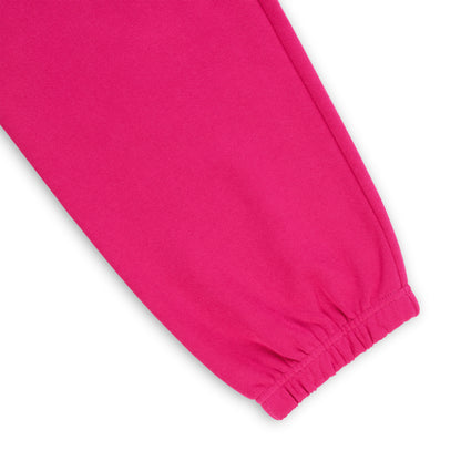 Close-up of a vibrant pink cotton fleece sweatpant leg with an elasticized cuff.
