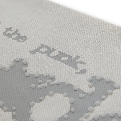 Close-up of light grey cotton fleece sweatpant with puff print "P*NK SP5DER" text and stars.