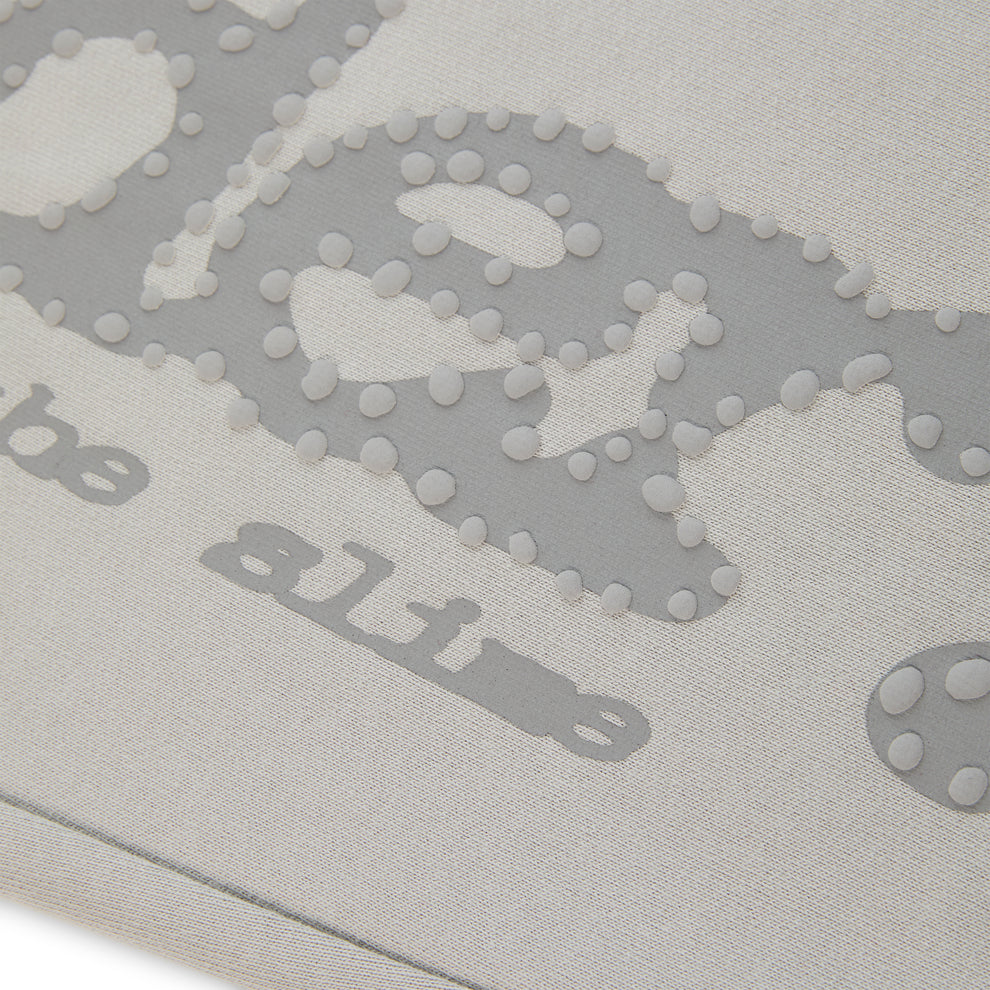 Light grey cotton fleece sweatpants with puff print "P*NK SP5DER" text and scattered stars.