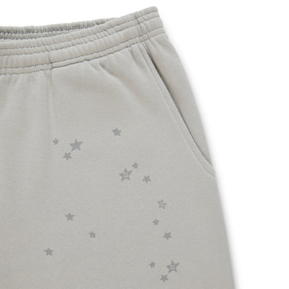 Gray cotton fleece sweatpants with scattered star print and an elasticized waistband.