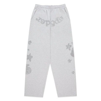 Gray wide-leg sweatpants with rhinestone 'SP5DER' text at crotch and star designs.