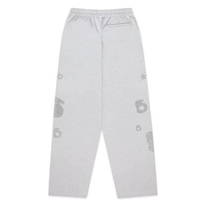 Light grey wide-leg sweatpants with rhinestone '5' and star designs, elastic waistband.