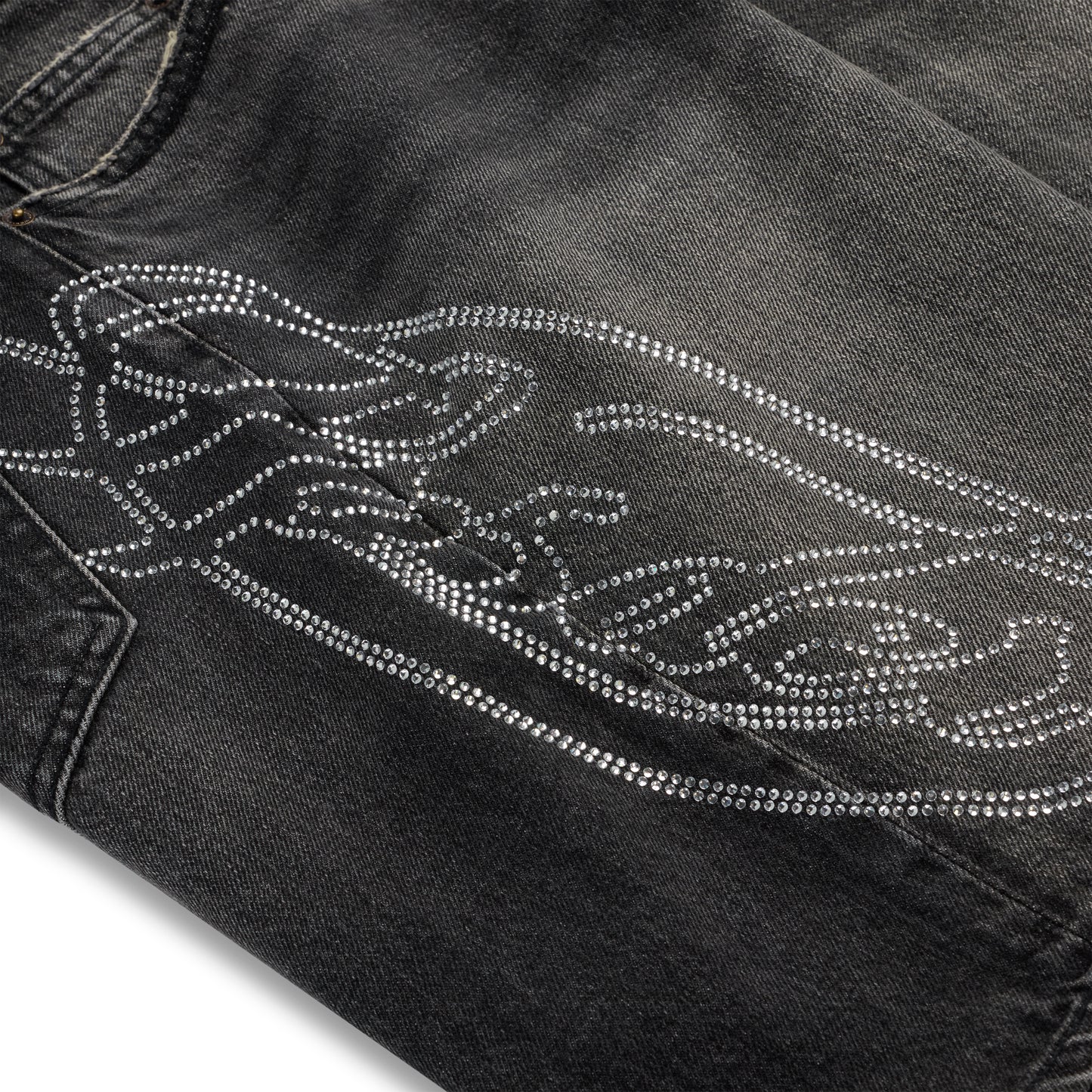 Vintage wash black denim shorts with a large rhinestone web and text design.