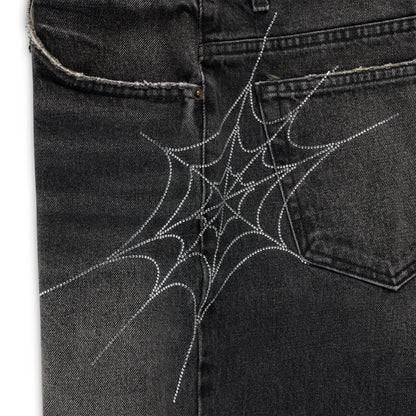 Vintage wash black denim shorts with a sparkling rhinestone spider web design on the back pocket.