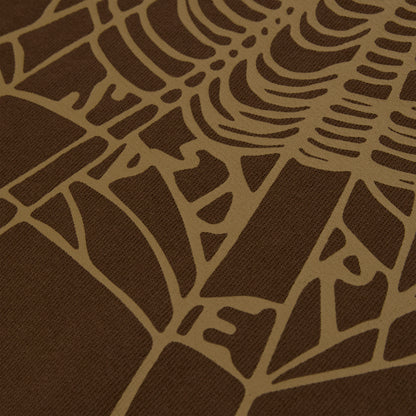 Close-up of a brown cotton fleece hoodie with a tan rhinestone web and text detail.