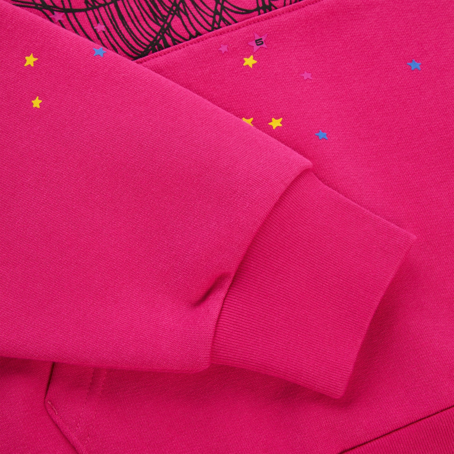 Pink 100% cotton fleece hoodie with scattered star print and ribbed cuff.