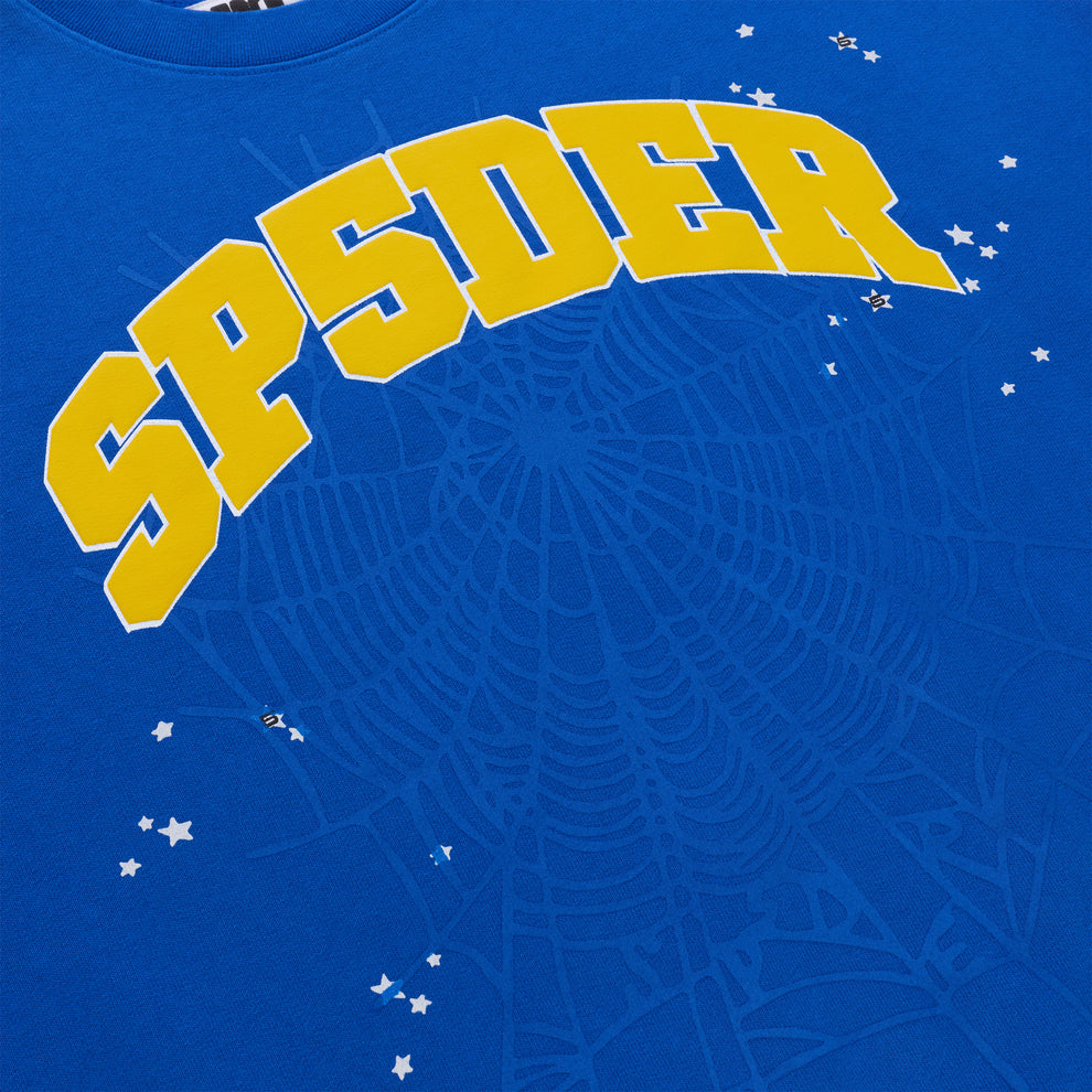 Blue crewneck sweatshirt with bold yellow "SP5DER" varsity lettering and small white star accents.