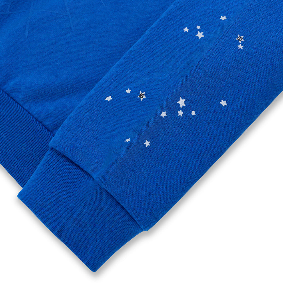 Blue crewneck sleeve with silver star print and ribbed cuff detail.