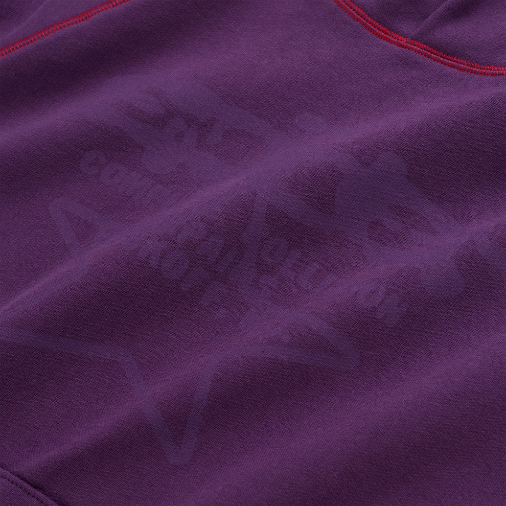 Purple 13oz cotton fleece hoodie with subtle graphic print and red contrast stitching.