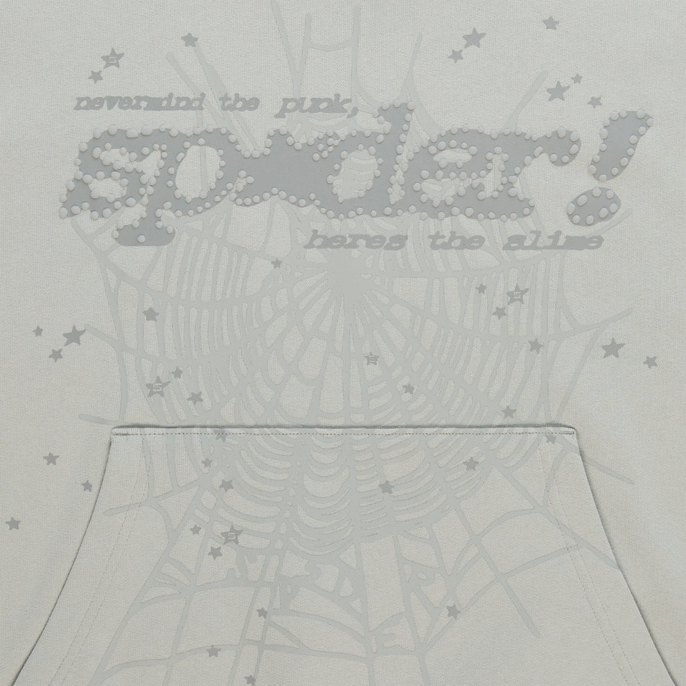 Light grey cotton fleece hoodie with "SP5DER!" puff print, spider web, and scattered star designs.