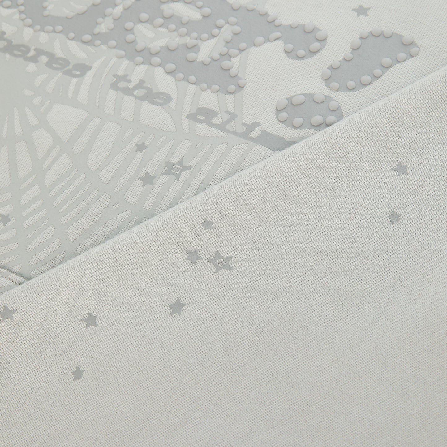 Light grey cotton fleece hoodie with puff print P*NK SP5DER motif, web, and scattered star design.