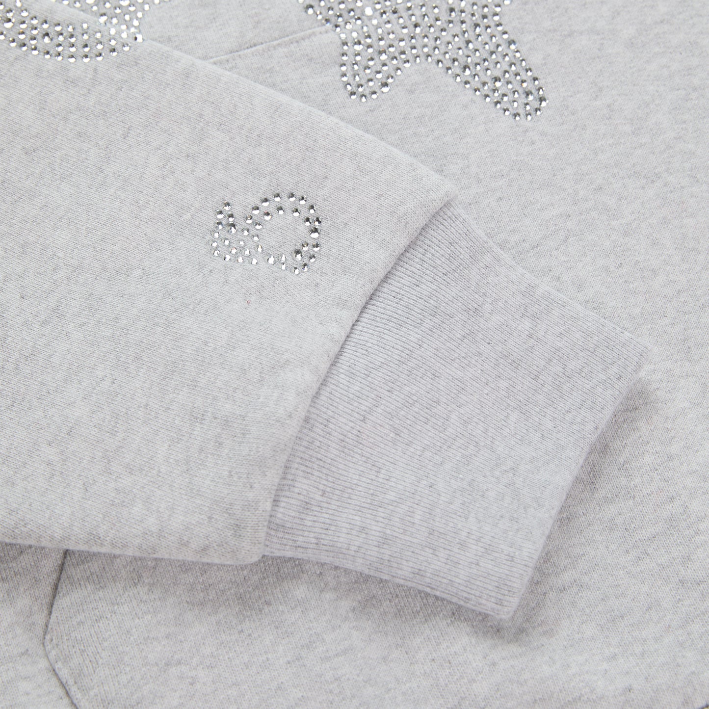 Light grey cotton fleece hoodie with rhinestone 'SP5DER' and star design on sleeve.