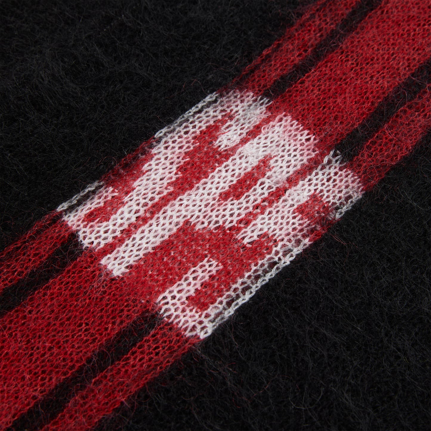Black mohair knit sweater with red and white vertical stripes and "SP5" logo.