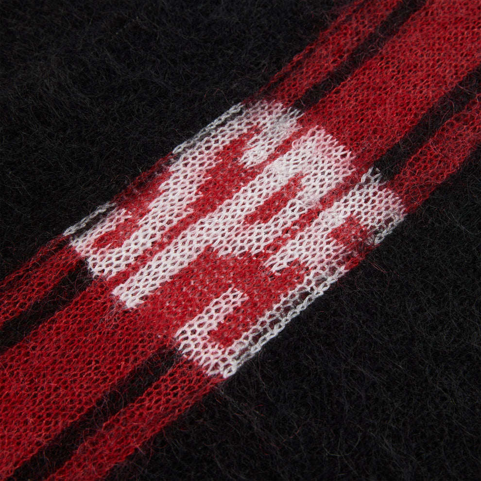 Black mohair knit sweater with red and white vertical stripes and "SP5" logo.