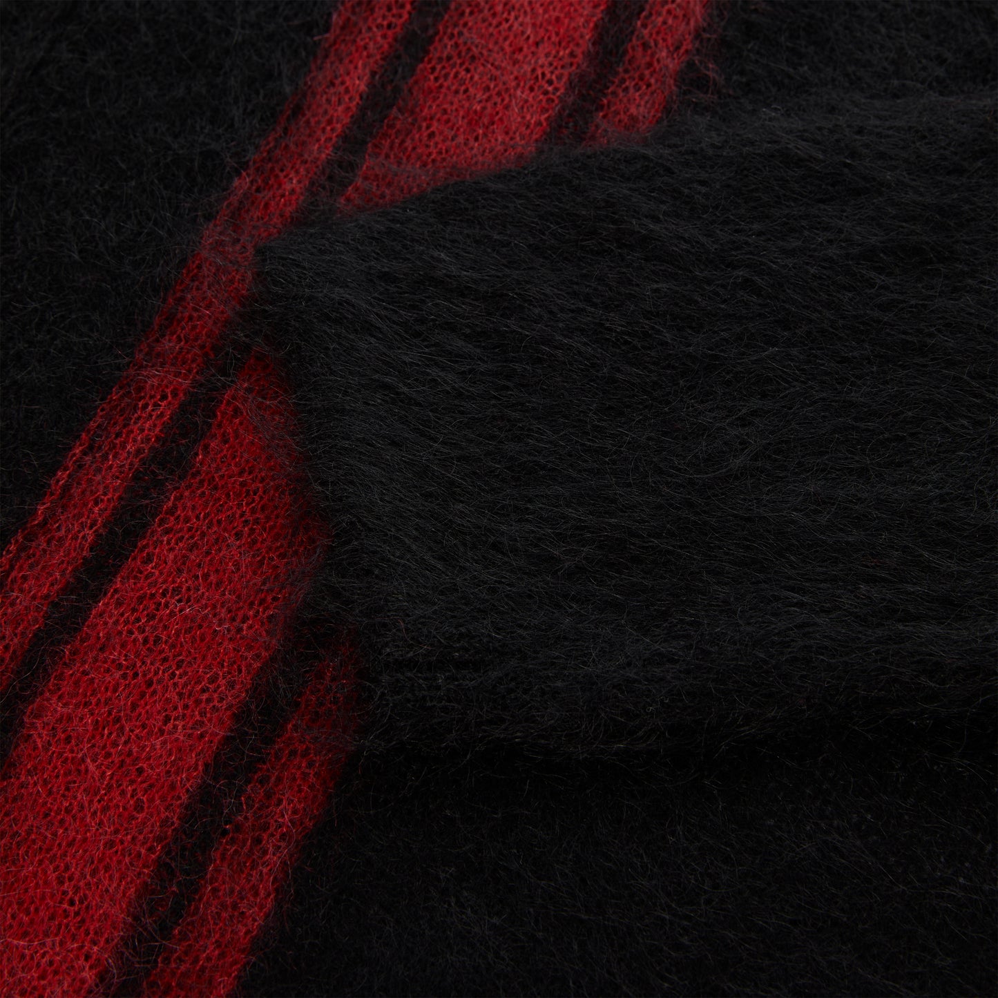 Black mohair knit sweater with red vertical stripes.
