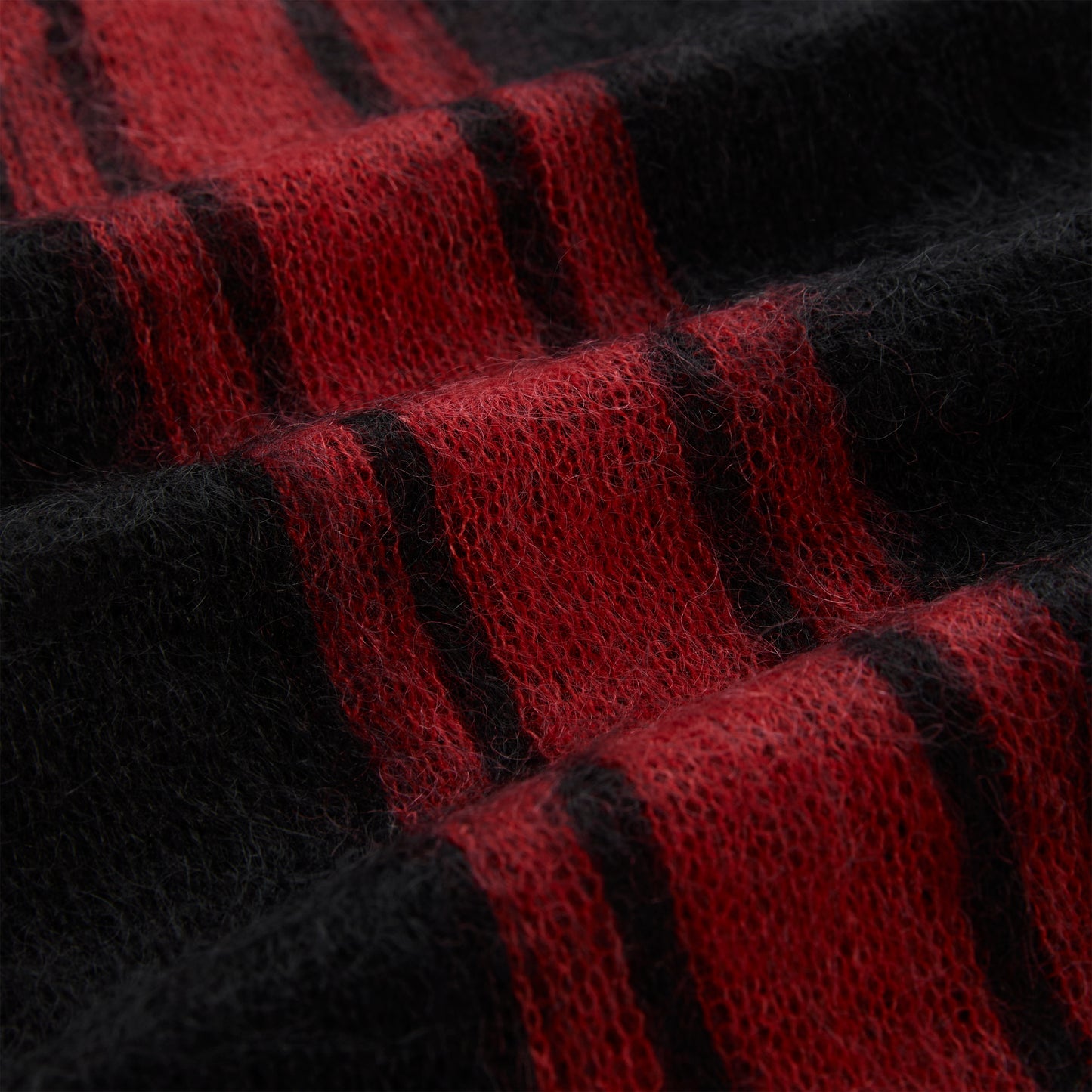 Red and black mohair knit sweater with vertical stripes and a fuzzy texture.