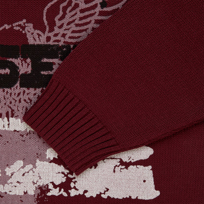 Maroon knit sweater with graphic print, ribbed cuffs, and textured fabric.