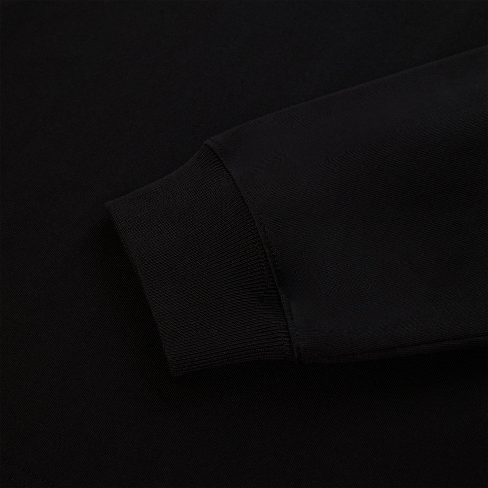 Close-up of a black 555 SP5DER long sleeve's ribbed cuff and sleeve, 100% cotton.