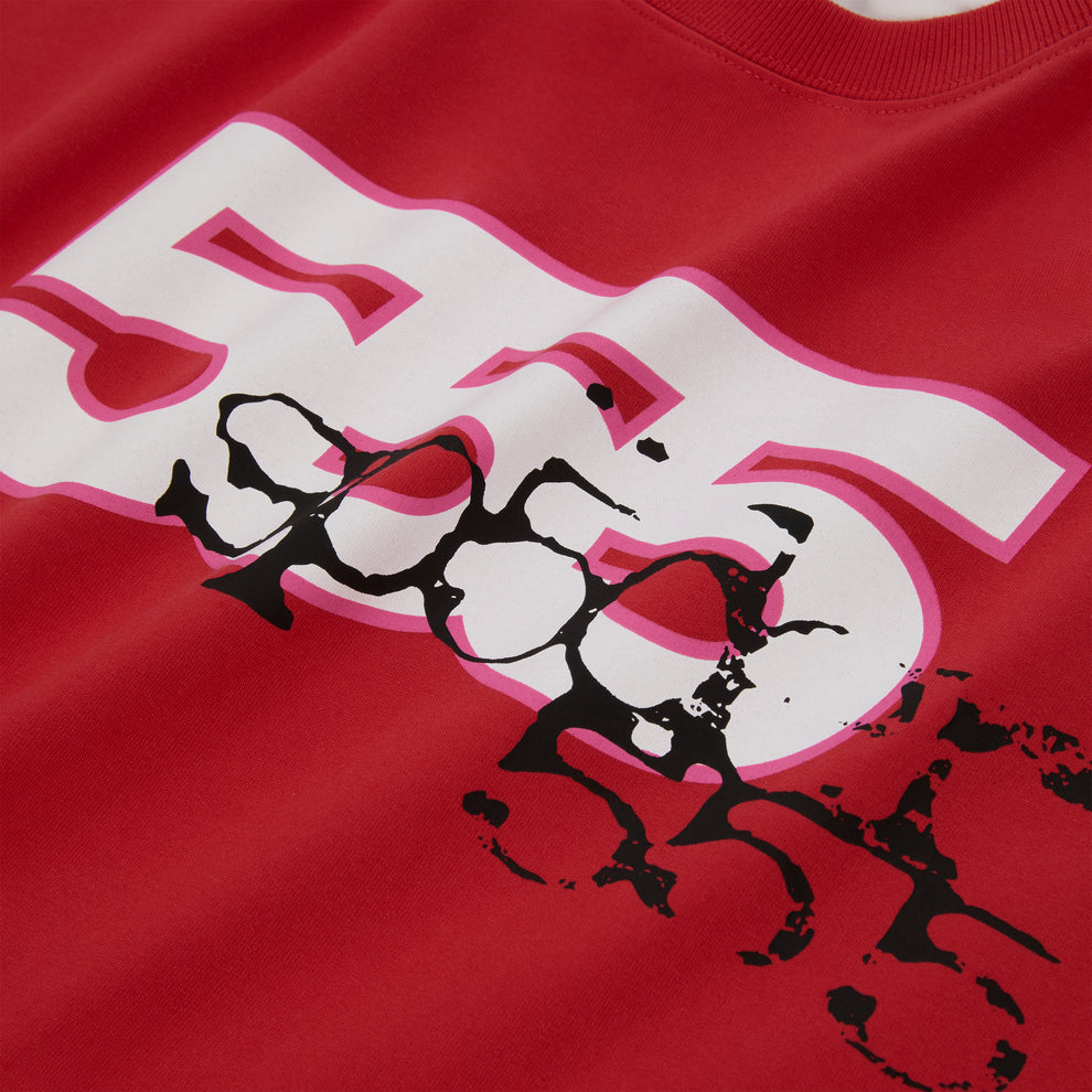 Red 555 SP5DER long sleeve tee with white and pink graphic print, ribbed collar and cuffs.