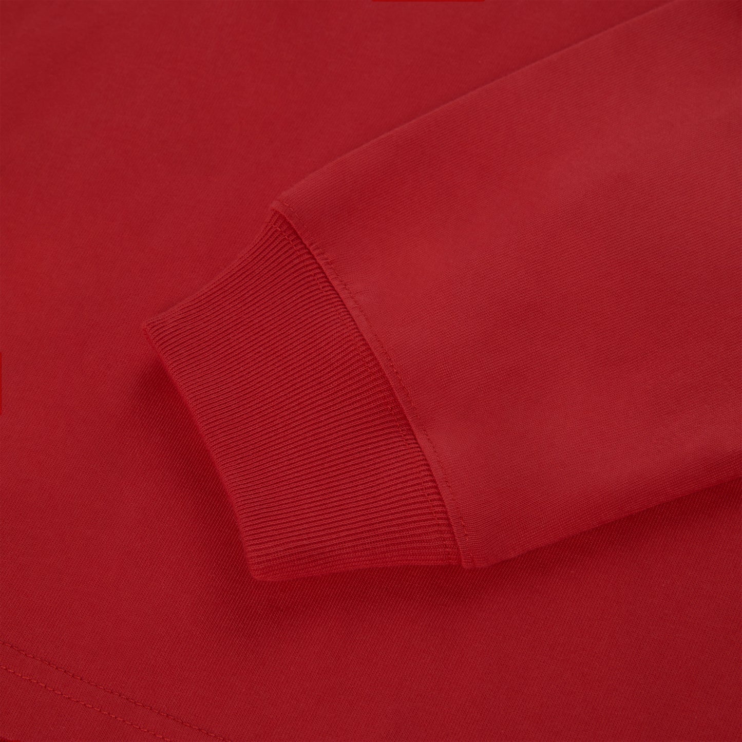 Close-up of a vibrant red 555 SP5DER long sleeve tee with ribbed cuffs.
