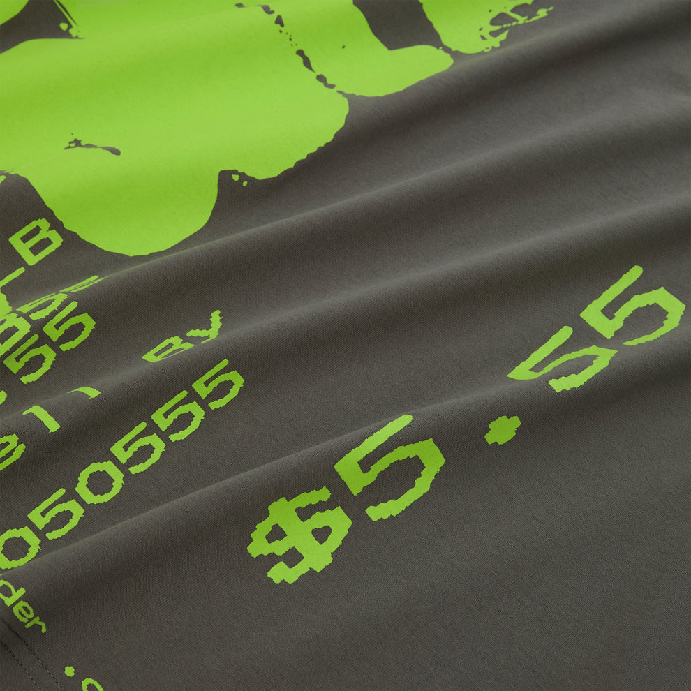 Close-up of a gray 100% cotton tee with a vibrant lime green graphic print featuring numbers and symbols.