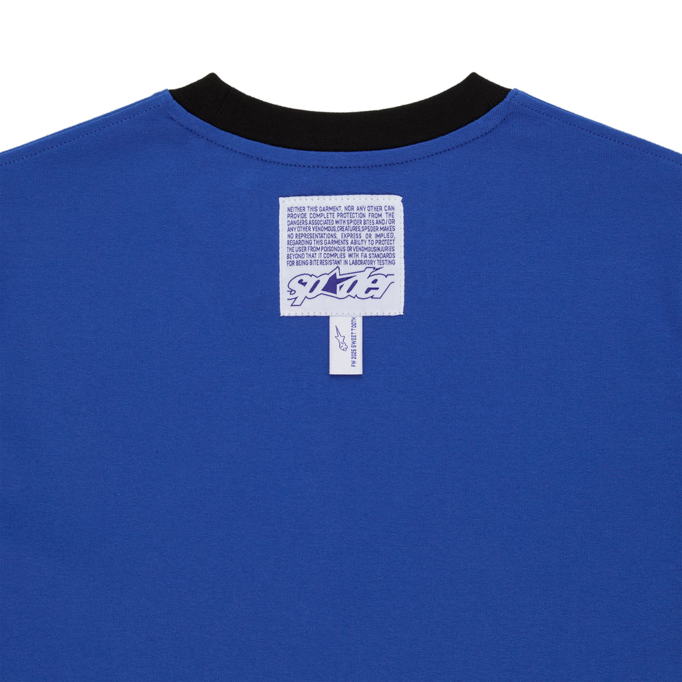 Back of blue cotton ENGINEER TEE with black contrast neck, woven logo label, and graphic print.