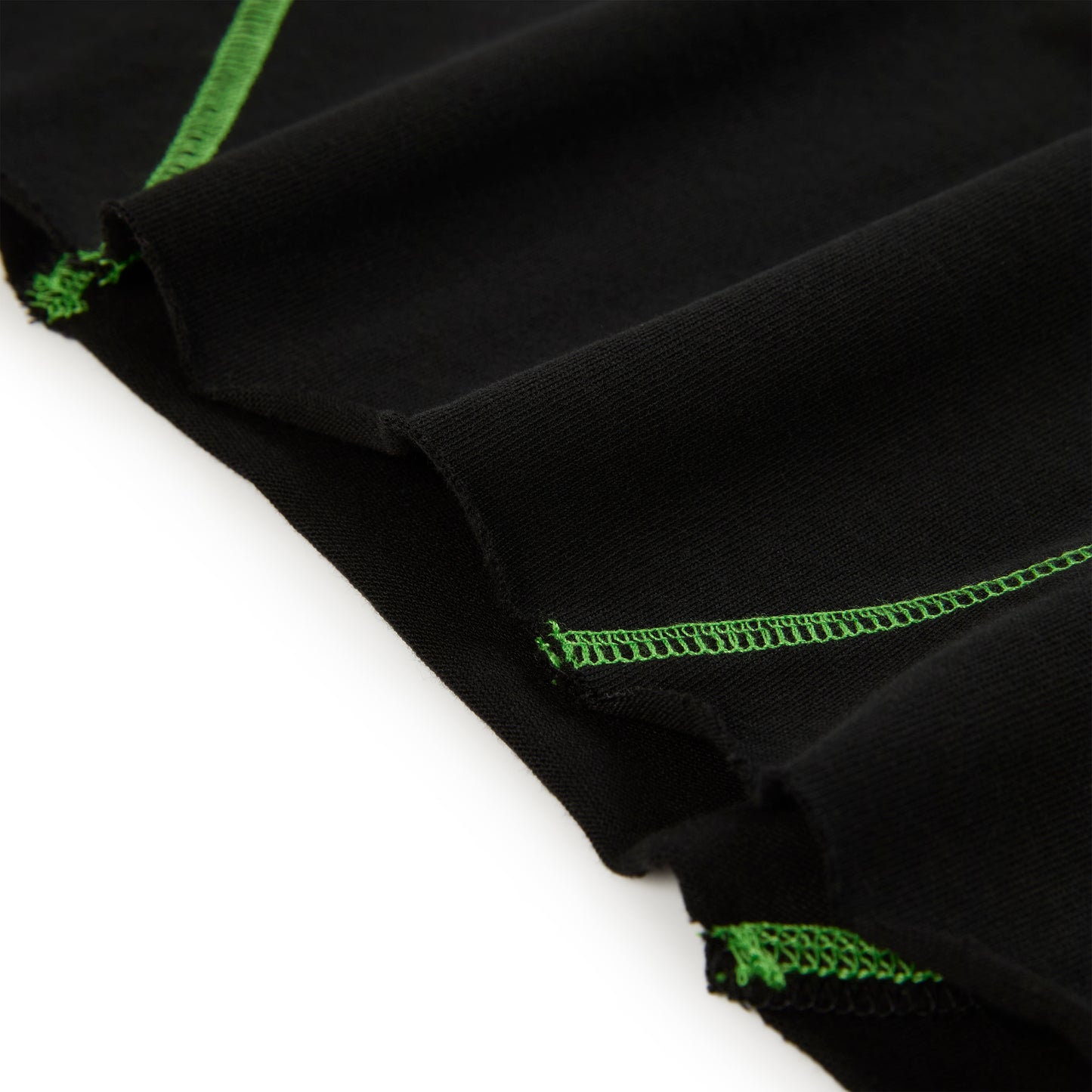 Black cotton long sleeve tee with bright green contrast stitching.