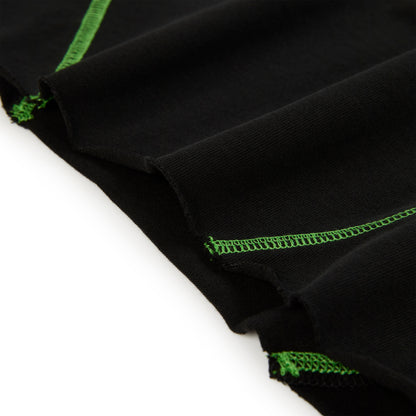 Black cotton long sleeve tee with bright green contrast stitching.