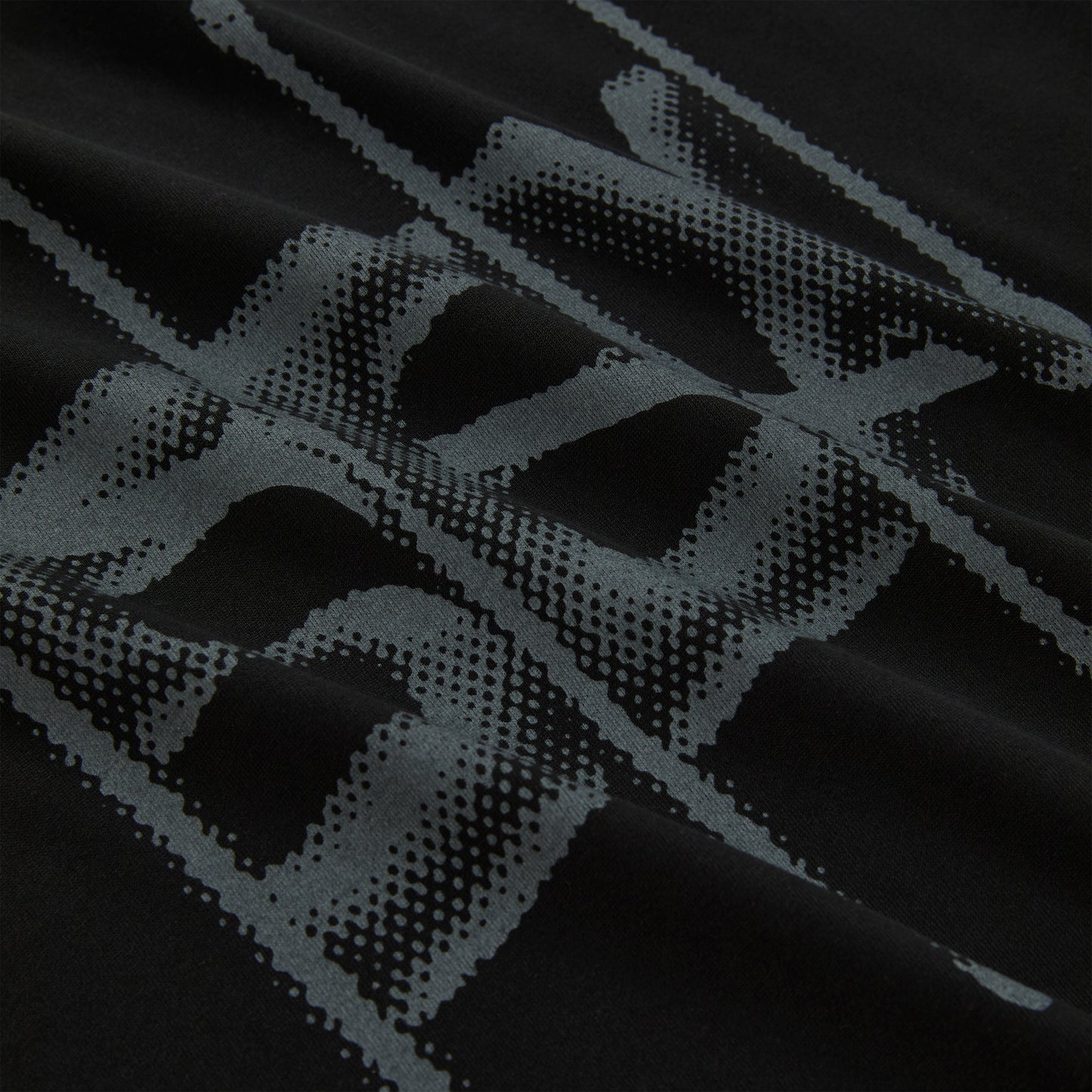 Black cotton long sleeve tee with a grey halftone graphic print.