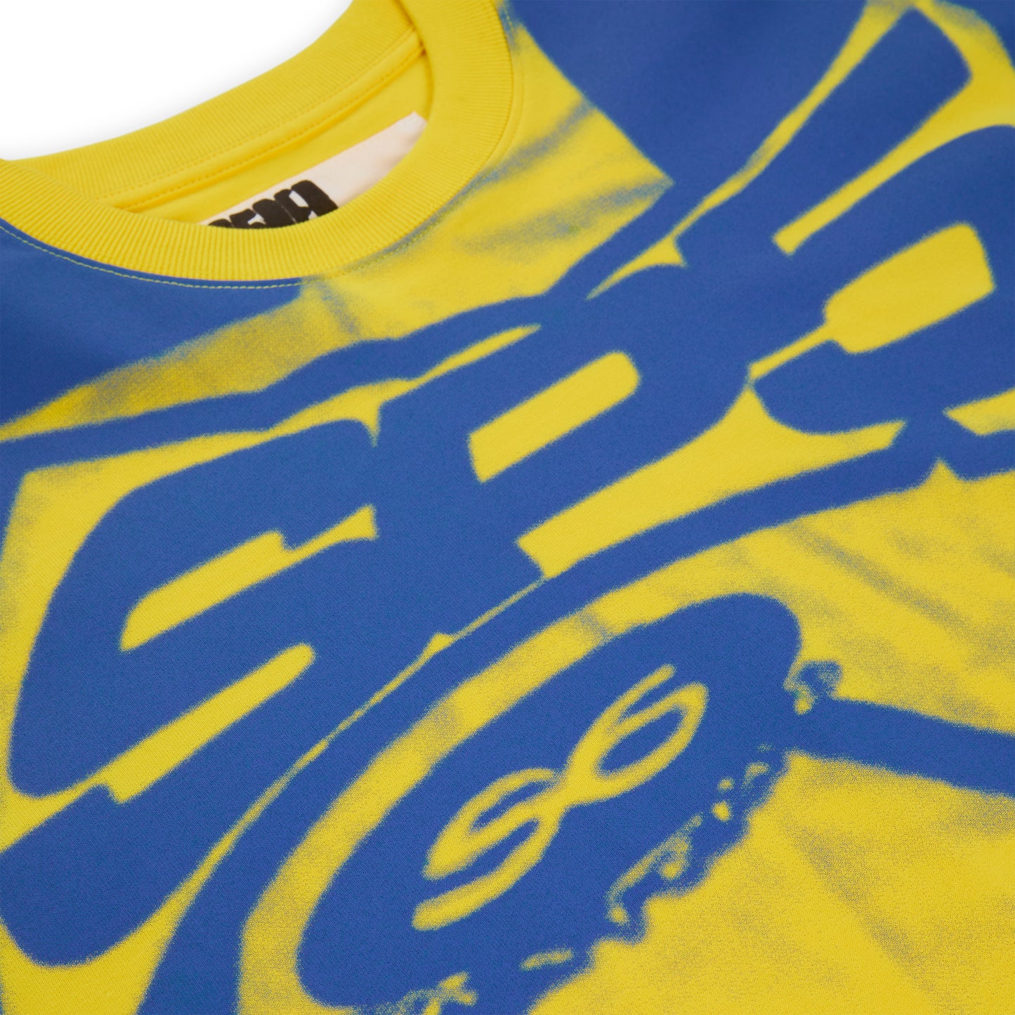 Yellow cotton long sleeve tee with blue graphic print, ribbed collar, and cuffs.