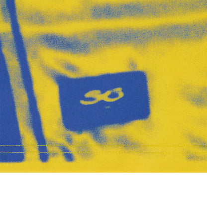 Yellow cotton long sleeve tee with blue spray paint graphic print and "SO" logo.