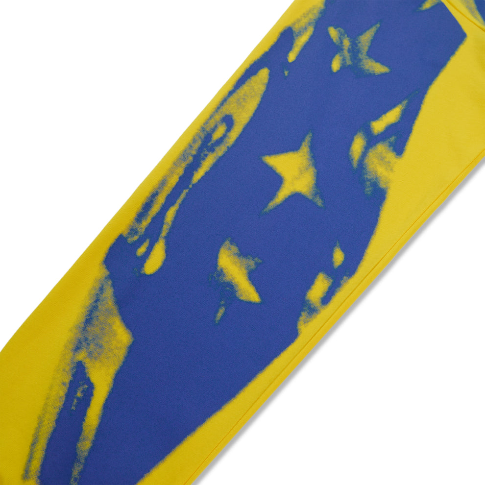 Yellow cotton long sleeve tee with a blue graphic print design featuring stars.